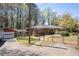 Brick ranch home featuring a fenced yard, a garage, and a covered side porch at 4693 Sugar Hill Se Rd, Acworth, GA 30102
