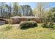 A cozy brick home with mature landscaping, a detached garage, and a well-kept lawn at 4693 Sugar Hill Se Rd, Acworth, GA 30102
