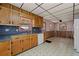 Traditional kitchen with wood cabinets, tile floors, and retro appliances at 4693 Sugar Hill Se Rd, Acworth, GA 30102