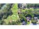 Gorgeous golf course home in a tranquil, wooded setting, as seen from above, circled in yellow for emphasis at 515 Butler National Dr, Johns Creek, GA 30097
