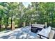Outdoor living space with comfortable wicker seating and lush landscaping, perfect for relaxing and entertaining at 515 Butler National Dr, Johns Creek, GA 30097