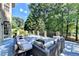 Secluded deck with comfortable wicker seating and lush landscaping, perfect for relaxing and entertaining at 515 Butler National Dr, Johns Creek, GA 30097