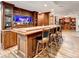 Basement bar area featuring cabinets, fish tank, and seating at 515 Butler National Dr, Johns Creek, GA 30097