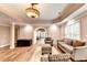 Bright basement living area with hardwood floors, comfortable seating, and natural light at 515 Butler National Dr, Johns Creek, GA 30097
