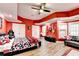Large red basement bedroom with guitars, a window, and dark ceiling fan at 515 Butler National Dr, Johns Creek, GA 30097