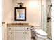 Bathroom featuring granite countertop, modern toilet, vanity mirror, and tiled walk-in shower at 515 Butler National Dr, Johns Creek, GA 30097