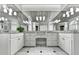Bright bathroom features double sinks with granite countertops, vanity area, and large mirrors at 515 Butler National Dr, Johns Creek, GA 30097