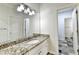 Full bathroom featuring granite countertops, large mirror, and updated fixtures at 515 Butler National Dr, Johns Creek, GA 30097