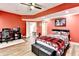 Spacious basement bedroom features desk, and bed with red accents at 515 Butler National Dr, Johns Creek, GA 30097