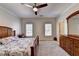Cozy bedroom with carpet, ceiling fan, dresser, and two windows with wooden blinds at 515 Butler National Dr, Johns Creek, GA 30097
