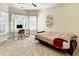 Bright bedroom featuring a work space, large windows, ceiling fan, and soft neutral carpet at 515 Butler National Dr, Johns Creek, GA 30097