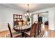 Sophisticated dining room featuring hardwood floors, ornate table, and traditional decor at 515 Butler National Dr, Johns Creek, GA 30097