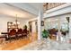 Formal dining room adjacent to the foyer with hardwood floors, chandelier, and elegant furnishings at 515 Butler National Dr, Johns Creek, GA 30097