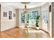 Bright dining room features hardwood floors, large windows, and an elegant chandelier at 515 Butler National Dr, Johns Creek, GA 30097