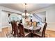 Elegantly appointed dining room with hardwood floors and a view towards the living area at 515 Butler National Dr, Johns Creek, GA 30097
