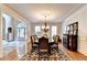 Traditional dining room featuring hardwood floors, chandelier, and a view to the foyer at 515 Butler National Dr, Johns Creek, GA 30097
