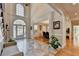 Spacious foyer with tile flooring, staircase, view into the formal dining room, and arched entryway at 515 Butler National Dr, Johns Creek, GA 30097
