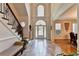 Grand foyer featuring soaring ceilings, tile flooring, staircase, and abundant natural light at 515 Butler National Dr, Johns Creek, GA 30097