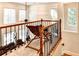 Cozy loft area featuring hardwood railing and a view of large windows at 515 Butler National Dr, Johns Creek, GA 30097