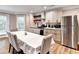 Bright eat-in kitchen with stainless steel appliances, stylish cabinets, wood floors and view of the backyard at 515 Butler National Dr, Johns Creek, GA 30097