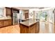 Open kitchen with granite counters, stainless appliances, and large center island at 515 Butler National Dr, Johns Creek, GA 30097