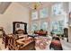 This grand living room has ornate wood furniture, high ceilings, and a chandelier at 515 Butler National Dr, Johns Creek, GA 30097