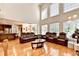 Open-concept living room with hardwood floors, great light, and seamless flow to kitchen at 515 Butler National Dr, Johns Creek, GA 30097