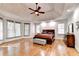 Spacious main bedroom featuring tray ceilings, hardwood floors, and lots of natural light at 515 Butler National Dr, Johns Creek, GA 30097