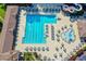 Aerial view of a community pool featuring a large lap pool, slides, and sunbathing deck with ample seating at 515 Butler National Dr, Johns Creek, GA 30097