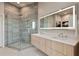 Bathroom featuring a large glass shower, double sinks and an illuminated mirror at 1080 Peachtree Ne St # 3507, Atlanta, GA 30309