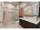 Bright bathroom featuring a glass shower, modern vanity and decorative wall art at 1080 Peachtree Ne St # 3507, Atlanta, GA 30309