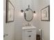Stylish powder room featuring shiplap walls, framed art, and modern vanity with oval mirror at 15 Paces West Nw Dr, Atlanta, GA 30327