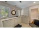 Bright bathroom with patterned wallpaper, long countertop, and a round mirror at 15 Paces West Nw Dr, Atlanta, GA 30327
