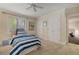 Neutral bedroom with twin closets, a ceiling fan and striped bedding at 15 Paces West Nw Dr, Atlanta, GA 30327