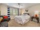 Light bedroom with a plush bed, striped curtains, and a comfortable sitting area at 15 Paces West Nw Dr, Atlanta, GA 30327