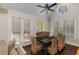 Bright dining room features a round window, wood floors, vaulted ceiling and woven chairs around a wooden table at 15 Paces West Nw Dr, Atlanta, GA 30327