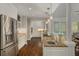 Spacious kitchen with stainless steel appliances, hardwood floors, granite counters, and custom white cabinetry at 15 Paces West Nw Dr, Atlanta, GA 30327