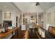 Bright open concept living room and kitchen with fireplace, beamed ceilings, hardwood floors and modern finishes at 15 Paces West Nw Dr, Atlanta, GA 30327
