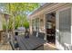Outdoor patio area with seating, gas grill, and heater; view into the dining room through sliding glass doors at 15 Paces West Nw Dr, Atlanta, GA 30327