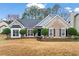 Charming brick home featuring a manicured front yard and inviting curb appeal at 3130 Goldmist Dr, Buford, GA 30519