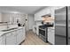 Bright kitchen with stainless steel appliances, including a gas range and refrigerator at 3130 Goldmist Dr, Buford, GA 30519