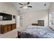 Main bedroom with a vaulted ceiling, carpet floor, and an ensuite bathroom entrance at 3130 Goldmist Dr, Buford, GA 30519