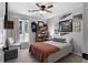 Comfortable bedroom with a ceiling fan, window, and sports memorabilia at 88 Hollyberry Ct, Dallas, GA 30157