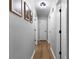 Well-lit hallway with hardwood floors and access to multiple rooms, providing a seamless flow throughout the home at 88 Hollyberry Ct, Dallas, GA 30157