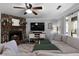 Cozy living room featuring a stone fireplace, large TV, and spacious sectional sofa at 88 Hollyberry Ct, Dallas, GA 30157