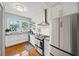 Bright kitchen featuring white cabinets, stainless steel appliances, and hardwood floors creating a modern cooking space at 907 Piedmont Ne Ave # 13, Atlanta, GA 30309