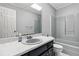 Bathroom featuring a single sink vanity, shower/tub combo, and updated fixtures at 250 Felton Dr, Fayetteville, GA 30214