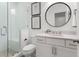 Modern bathroom featuring walk-in shower, patterned tile, frameless glass door, and vanity with white countertop at 261 Thompson St, Alpharetta, GA 30009