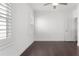 Bright bedroom with hardwood floors, shuttered windows, white walls, and a ceiling fan at 261 Thompson St, Alpharetta, GA 30009