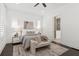 Cozy bedroom features neutral decor, plantation shutters, a ceiling fan, and a doorway leading to a bathroom at 261 Thompson St, Alpharetta, GA 30009